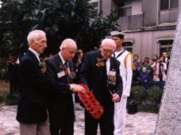 The survivors laying their wreath on the memorial.